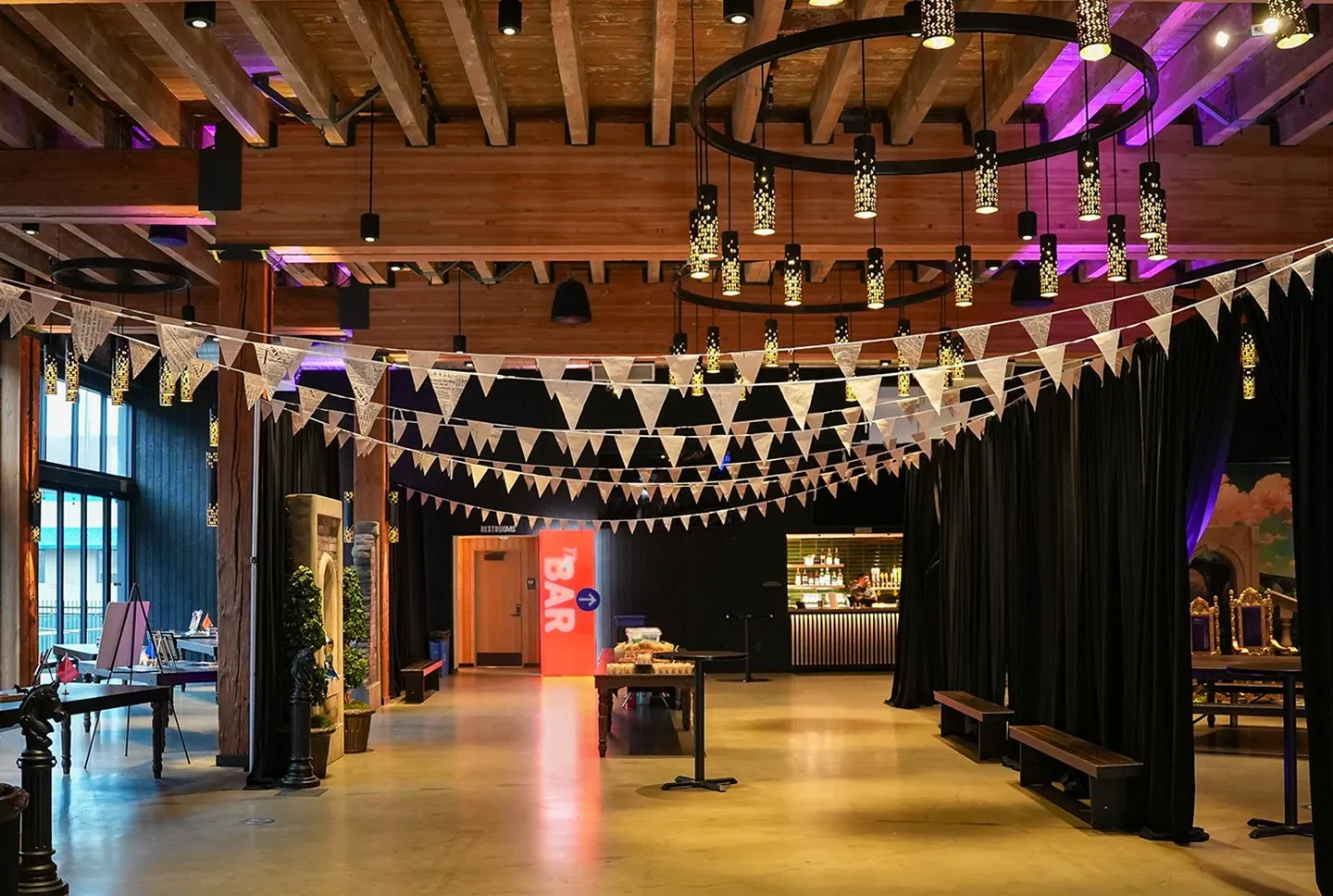 Event hall with bunting, pendant lighting and a bar area