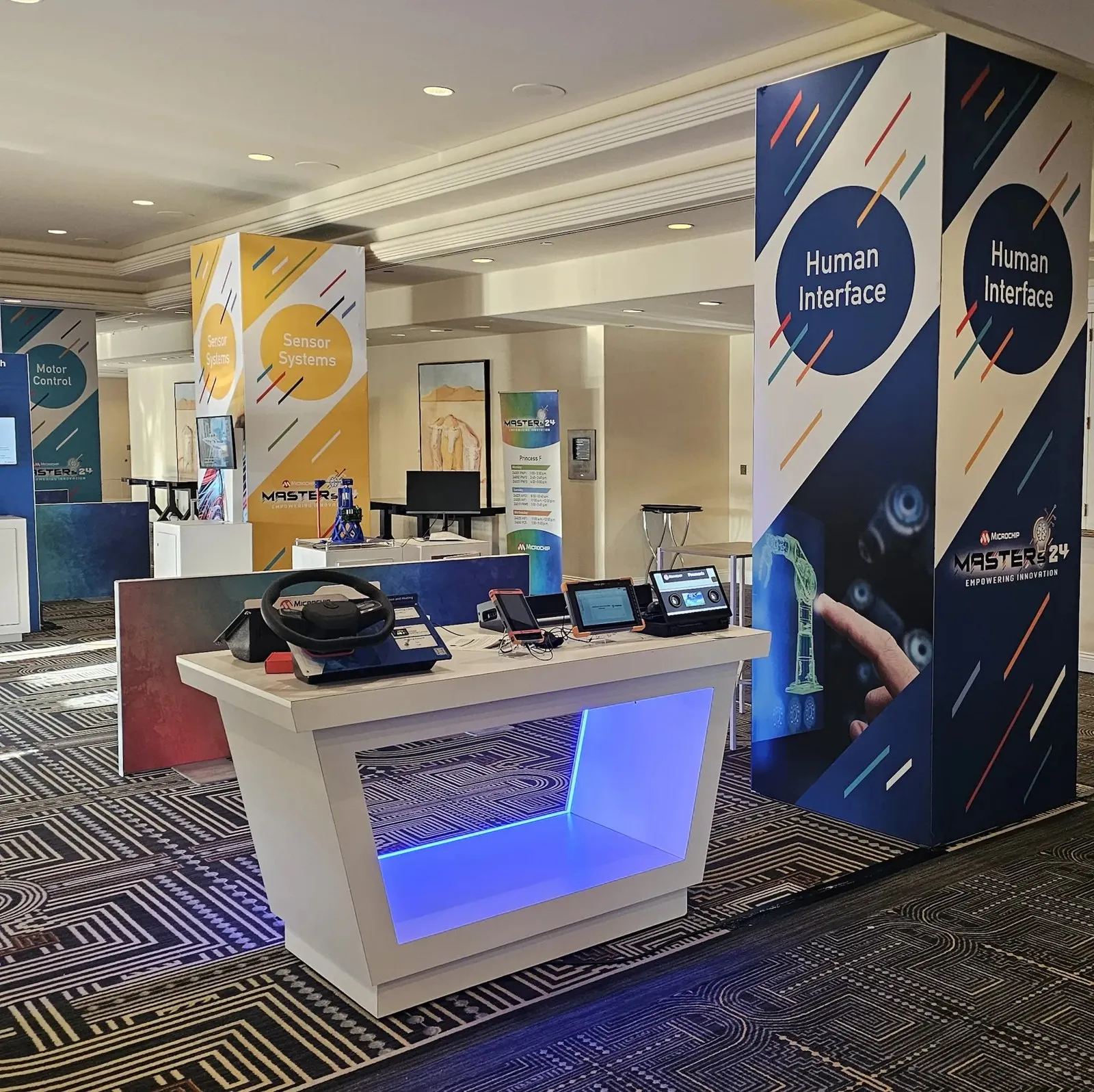 Branded registration counter and banners at a Microchip event