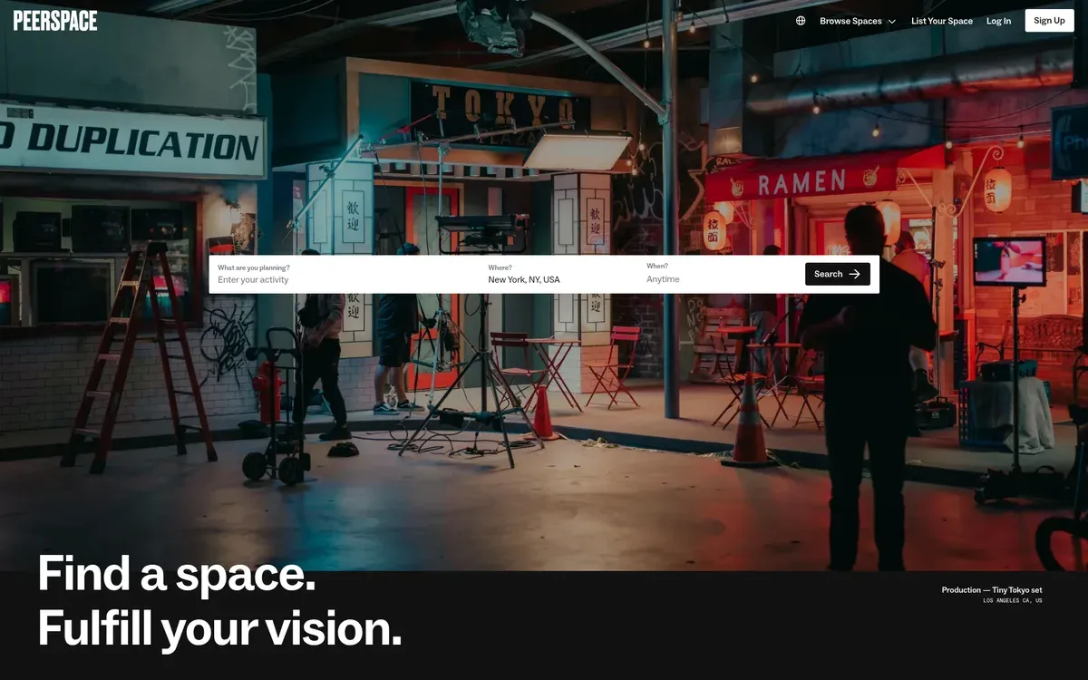The Peerspace homepage shows the headline "Find a space. Fulfill your vision." in large white type at the bottom left, under a search bar set to New York, NY. The full-width photo shows a dimly lit film set built as a Tokyo street, with ramen shop signs, a ladder, light stands and café chairs.