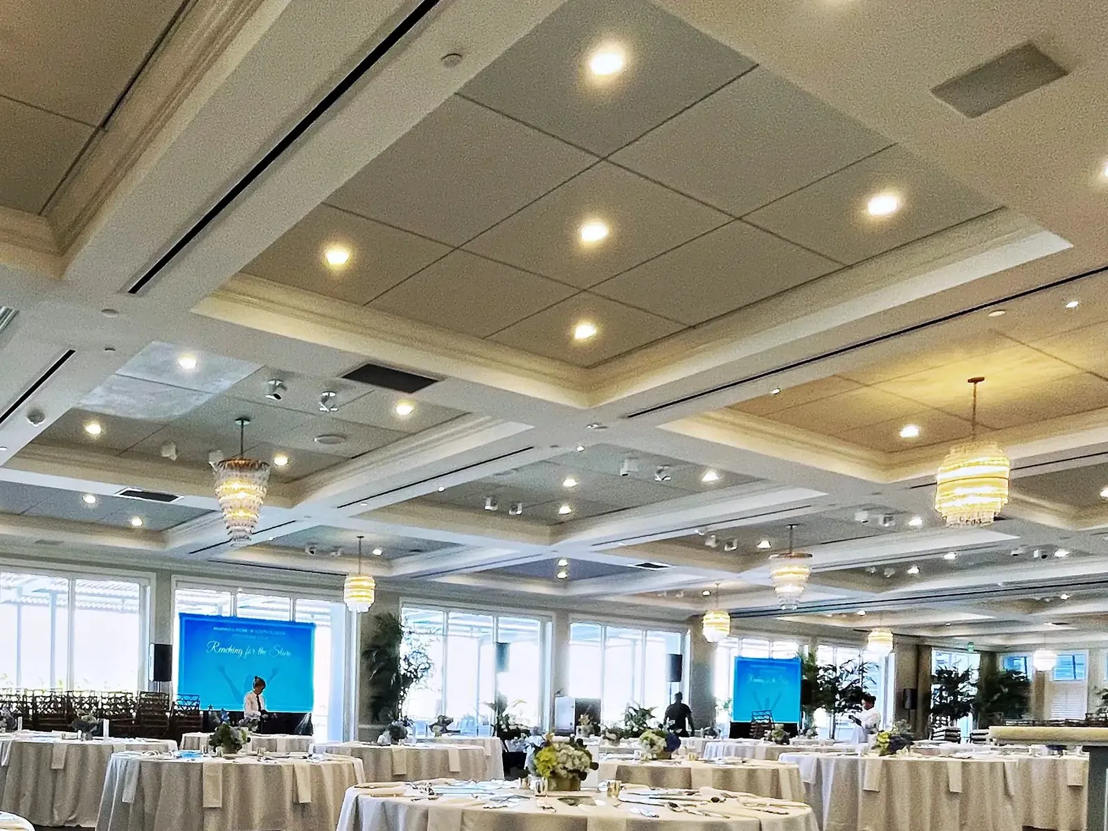 Banquet room set with rounds and video walls