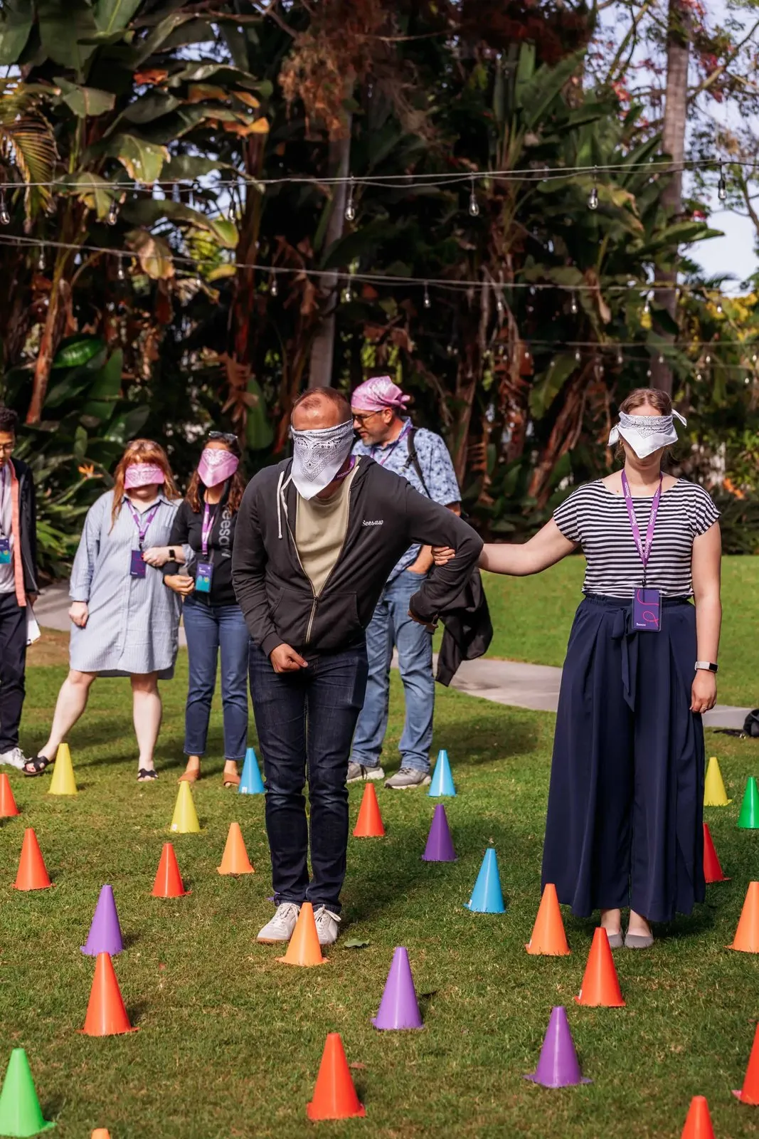 Team activity with cones on the lawn during the Seesaw retreat