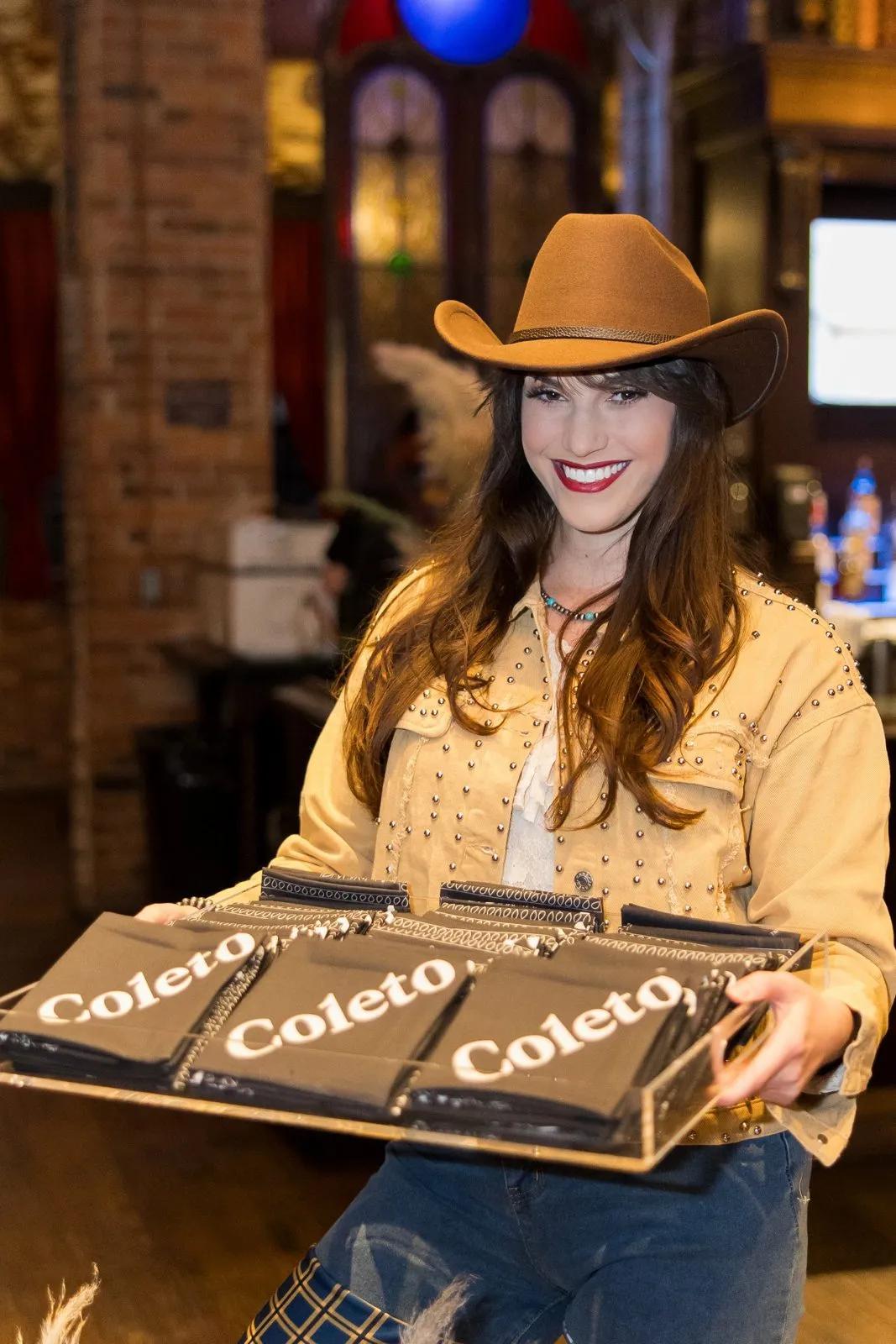 Guest in a cowboy hat holding a tray at an experiential activation