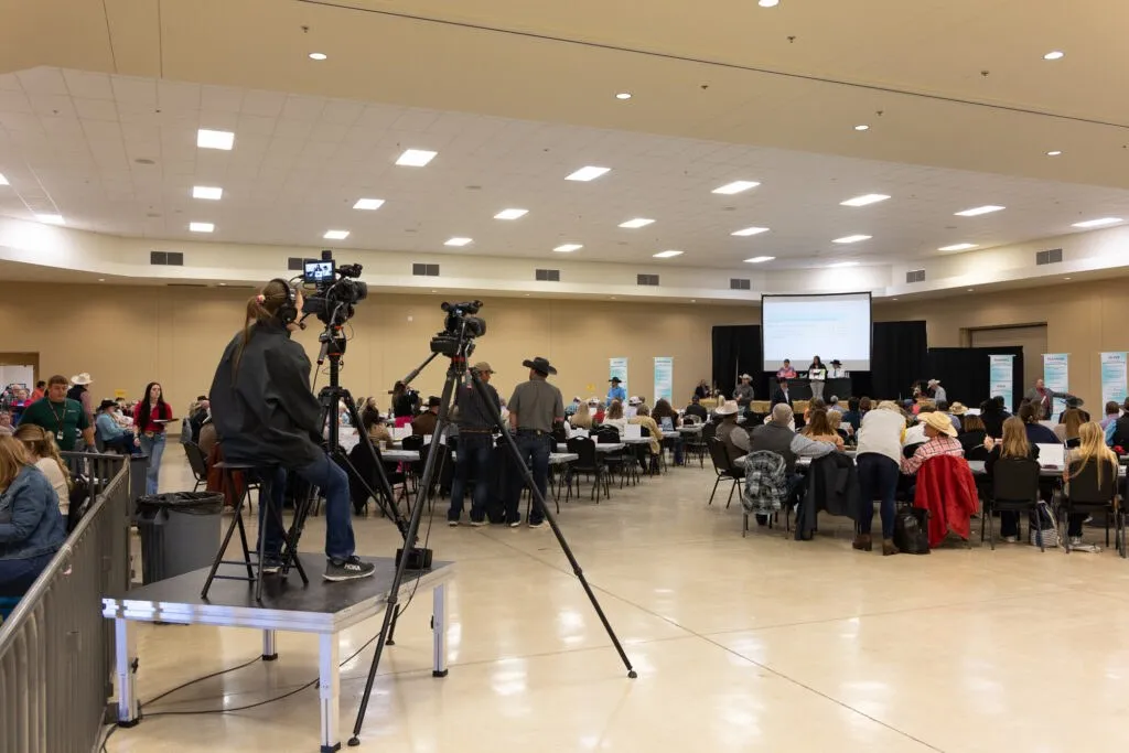 Camera operator filming an event in a hall