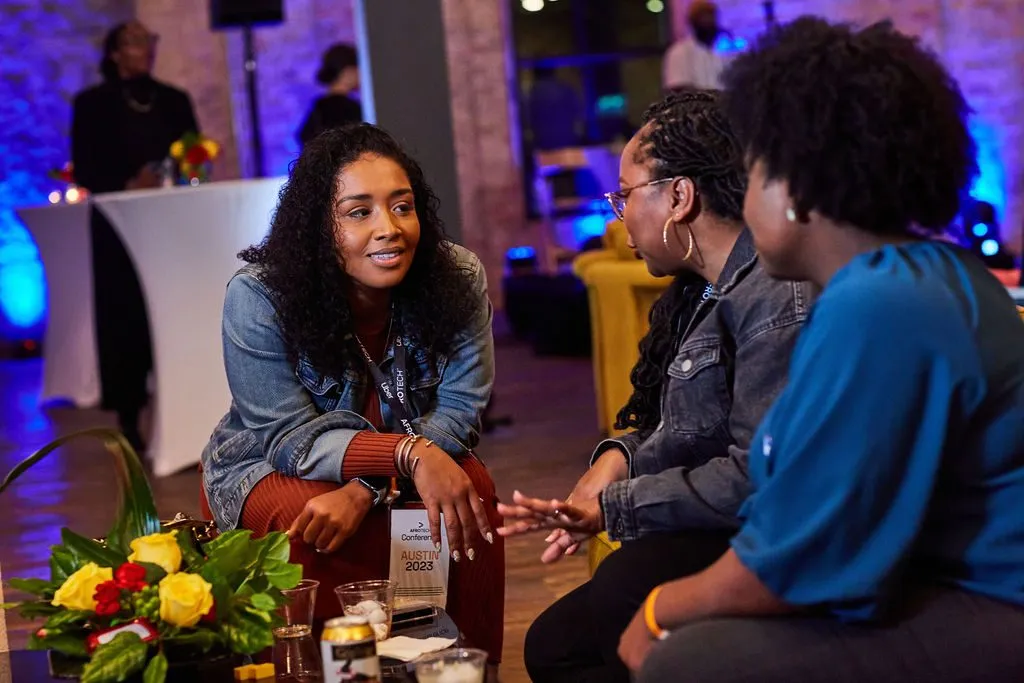 Attendees talking at a networking table with flowers