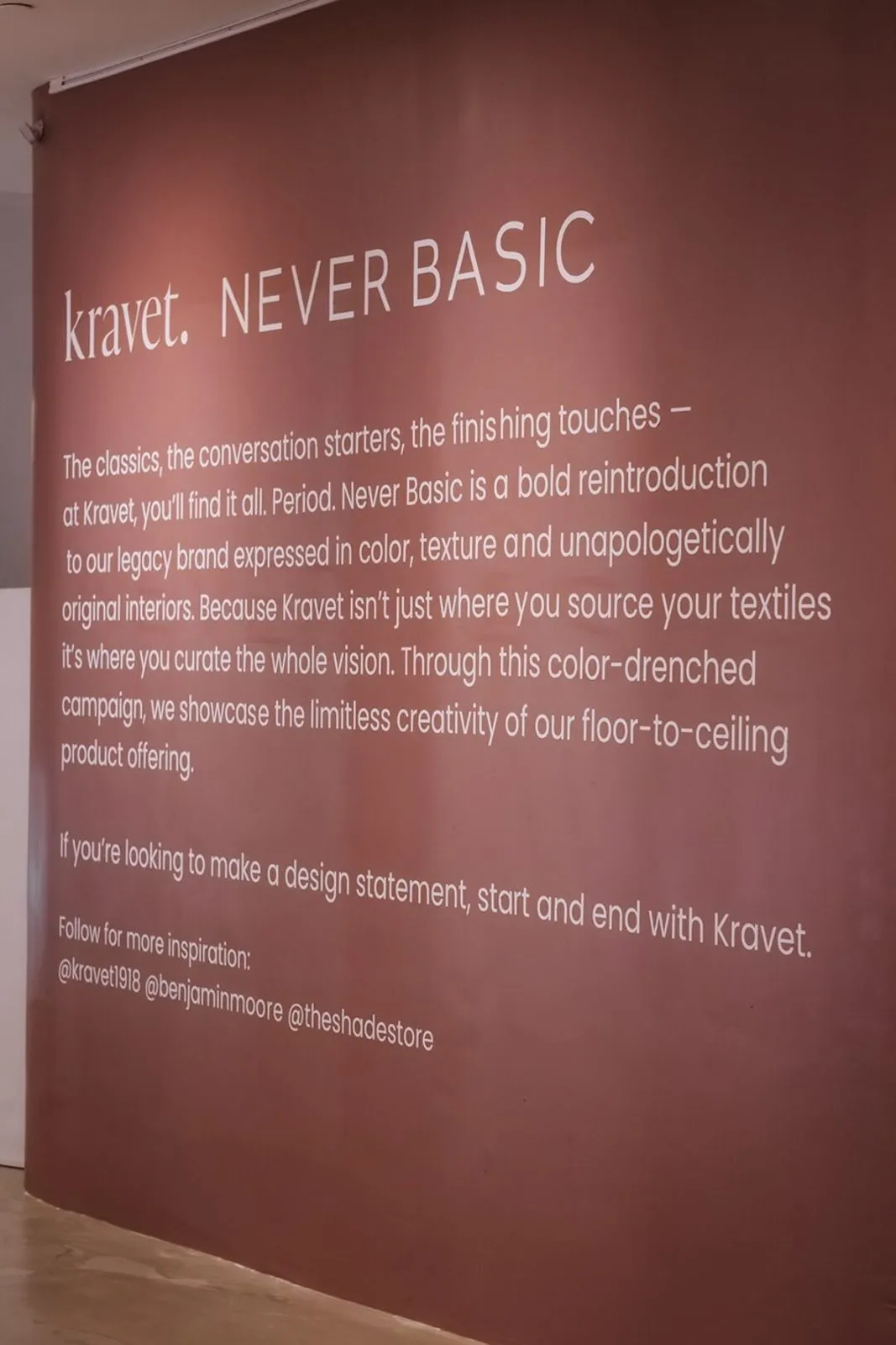 Brand activation wall with printed text on a deep red panel