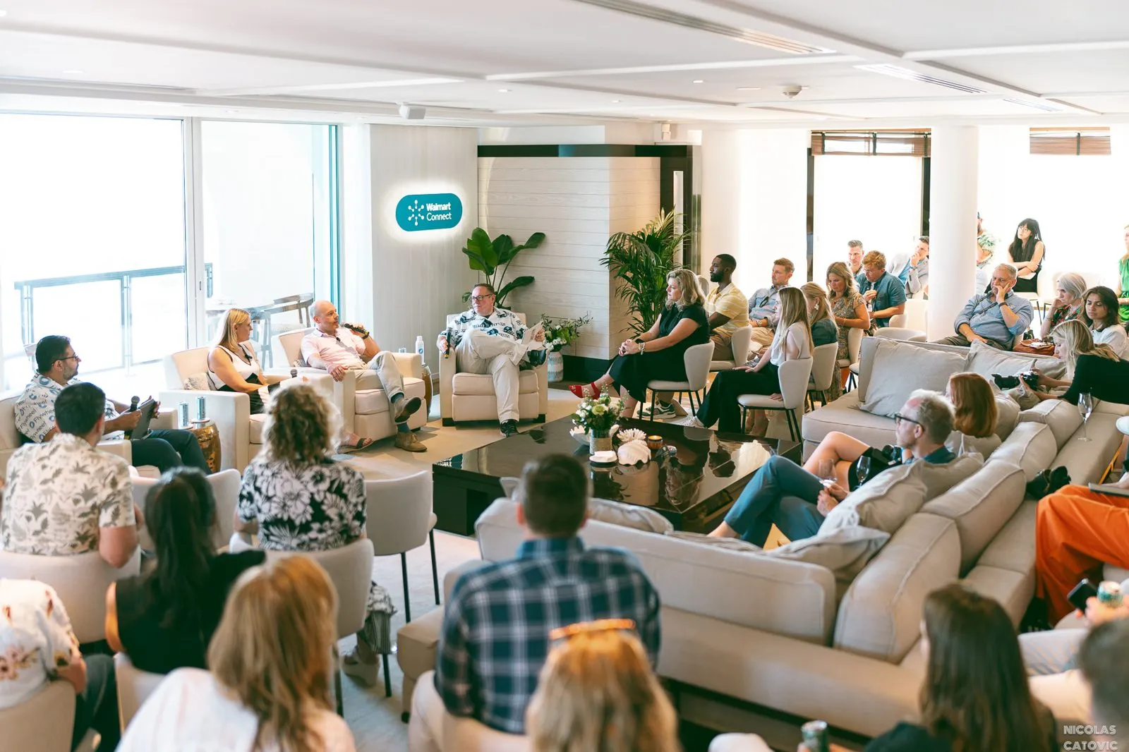 Audience seated in a lounge for a panel discussion