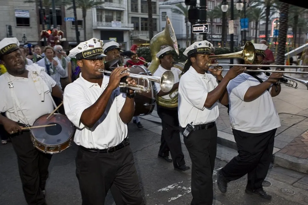 Brass band leading a second line for a group