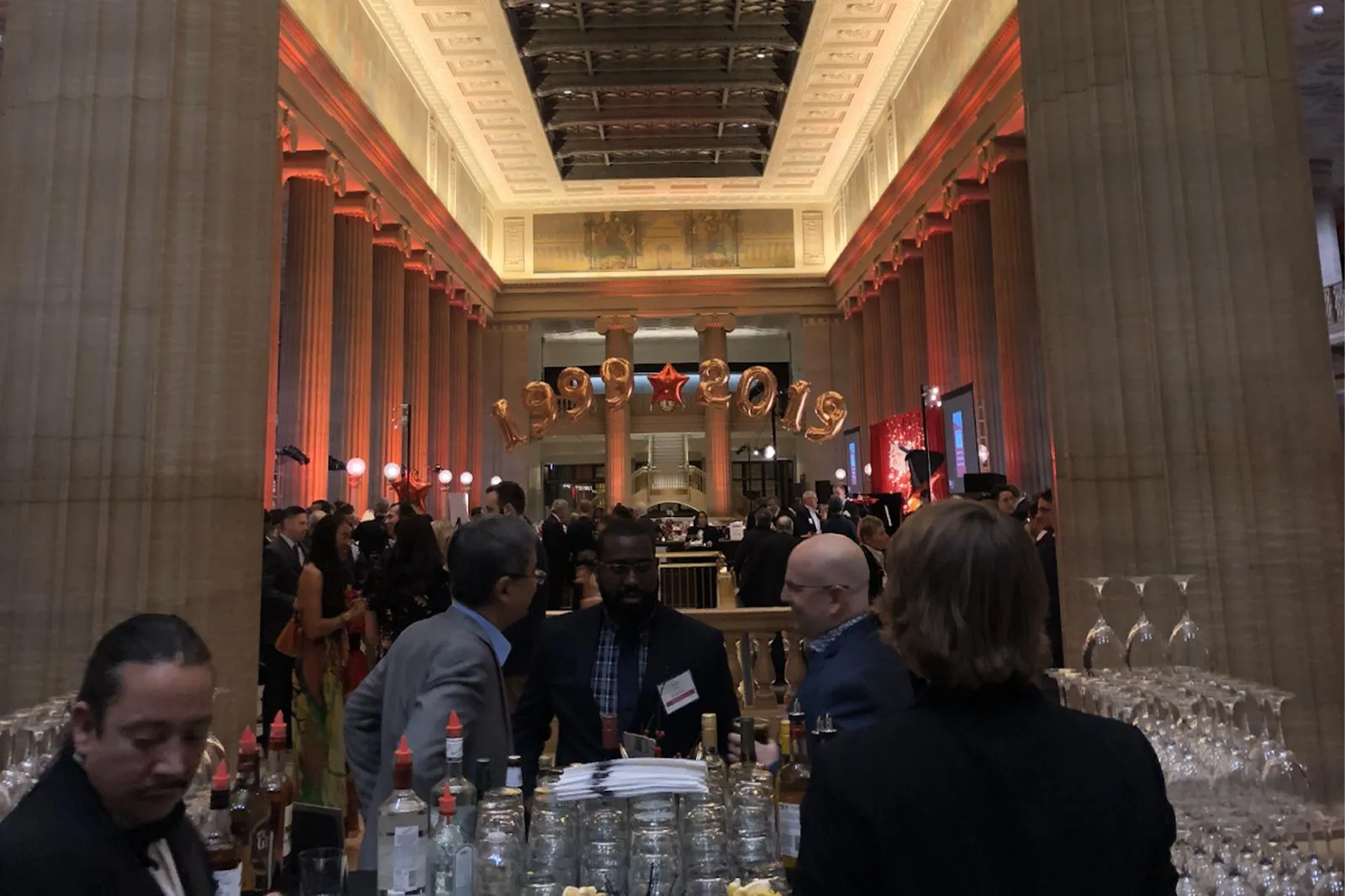 Guests at a reception in a grand coffered hall