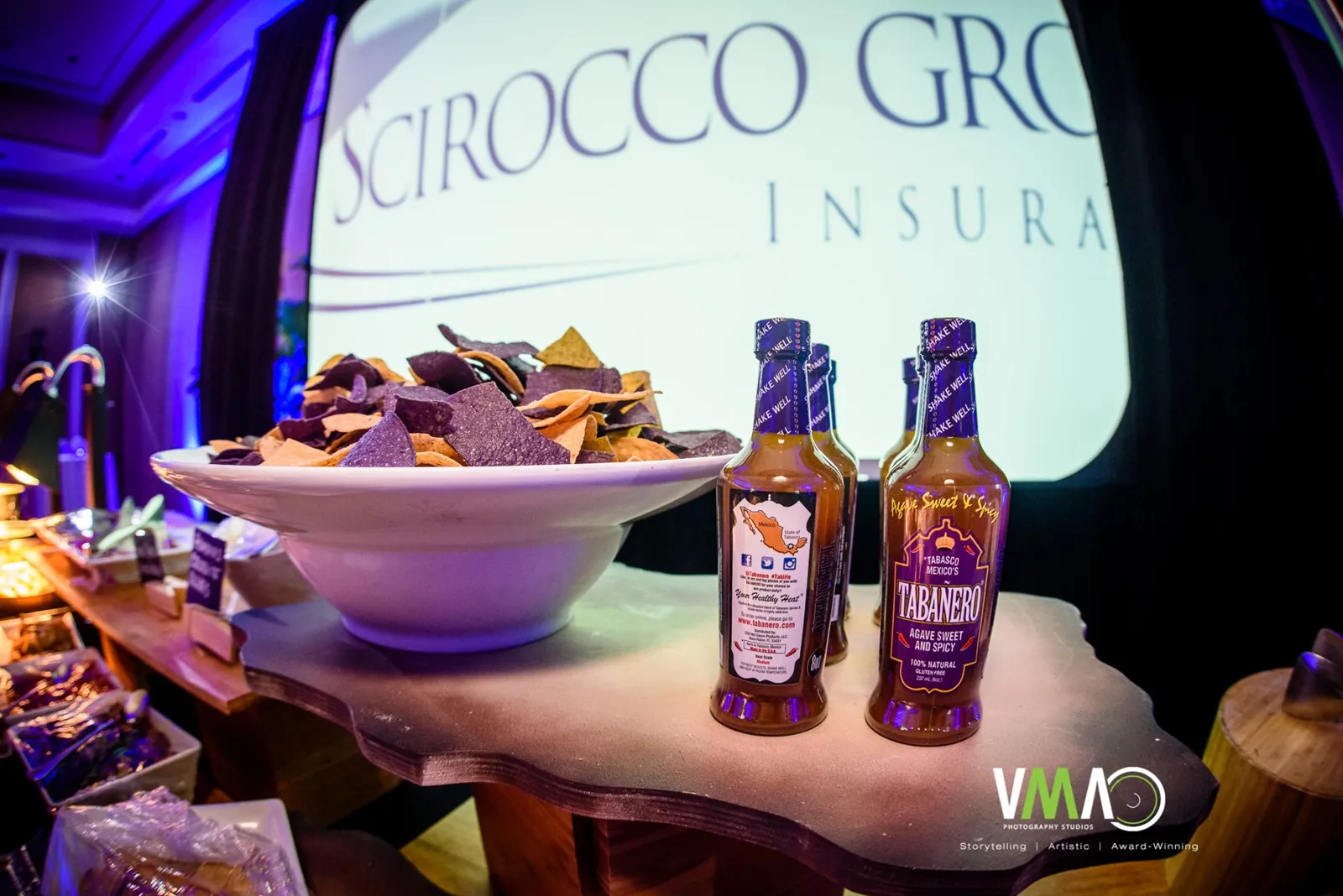 Sponsor food station with hot sauce bottles at the Luminary Gala