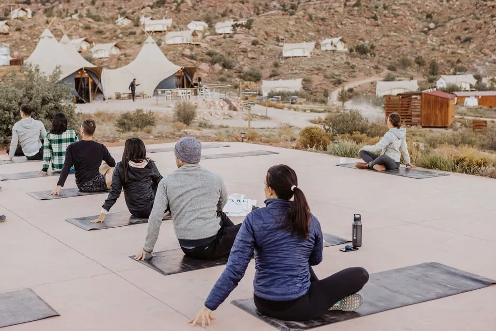 Retreat guests doing yoga at a glamping camp near Zion National Park