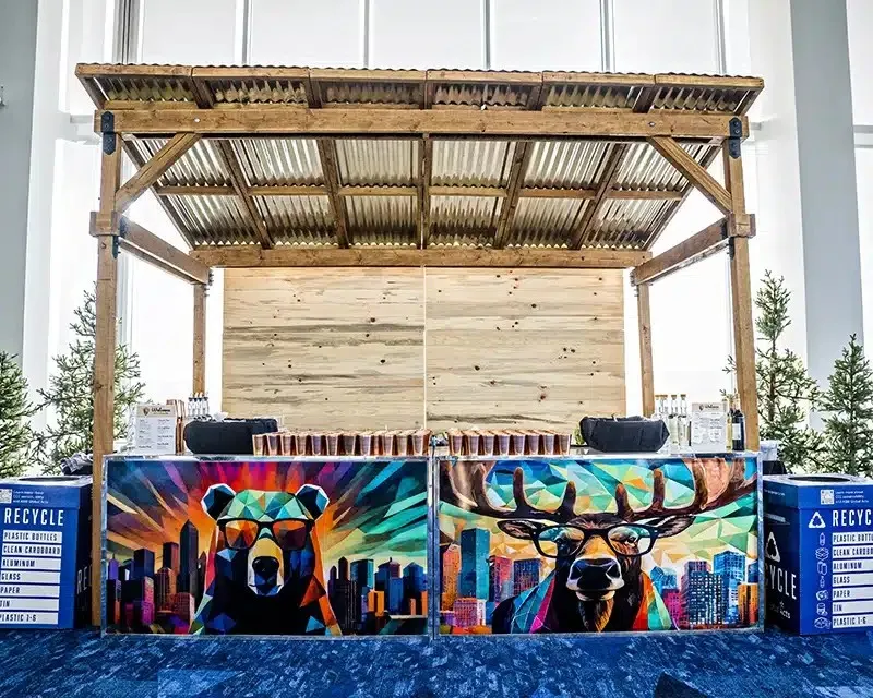 Wooden stage with a painted wildlife backdrop set up indoors