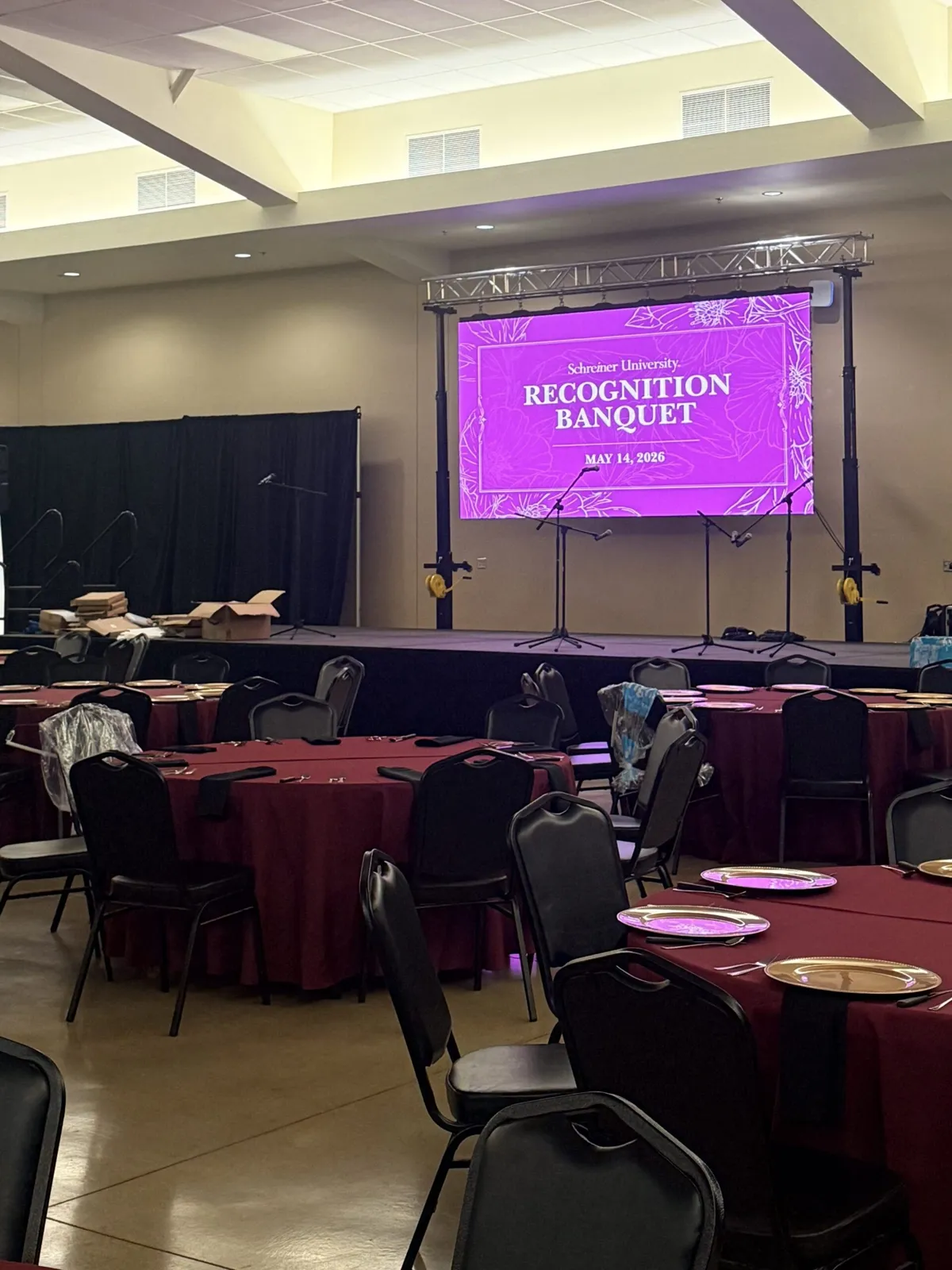 Presentation screen above a banquet set-up