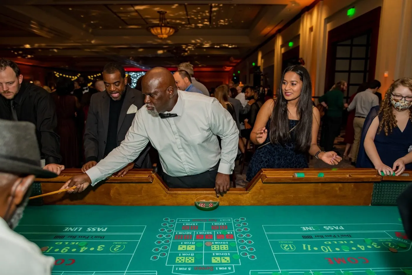 Guests at a craps table during a casino night event