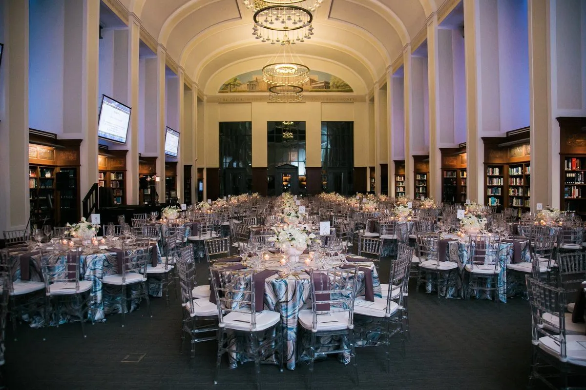 Grand hall set with round tables and candle centerpieces for a gala dinner