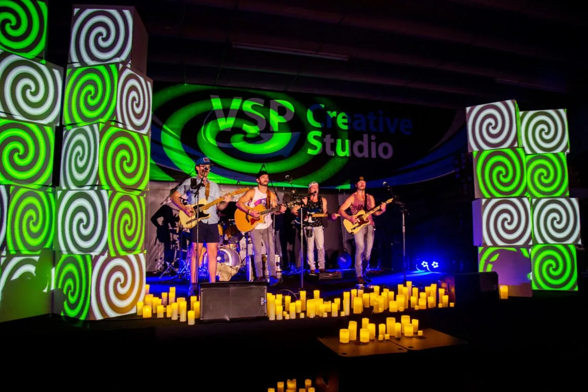 Outdoor concert stage with lit swirl set pieces