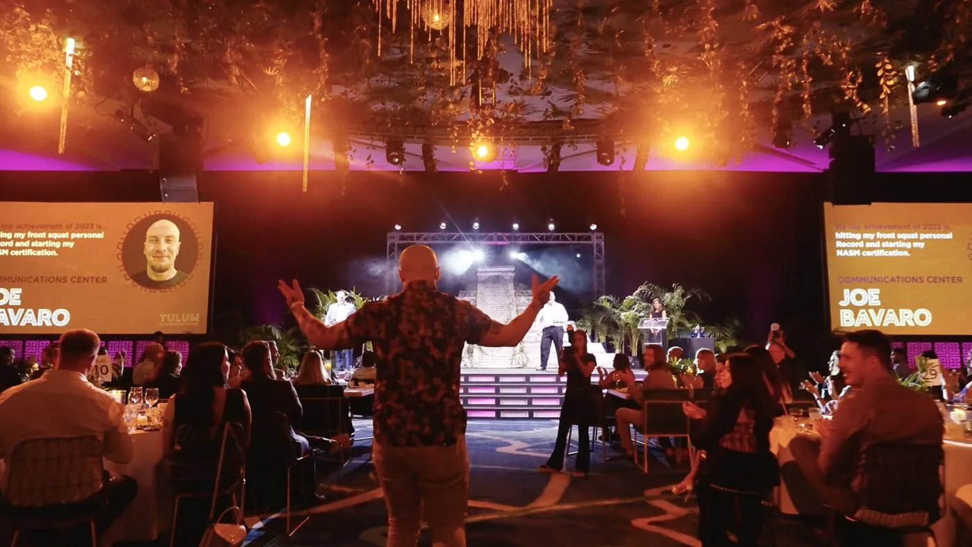 Company event with a speaker on stage and attendees in the audience