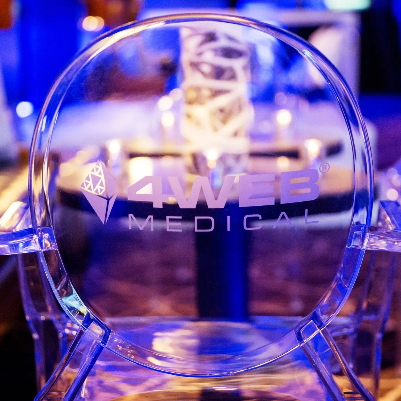 Branded transparent chair at an evening corporate dinner