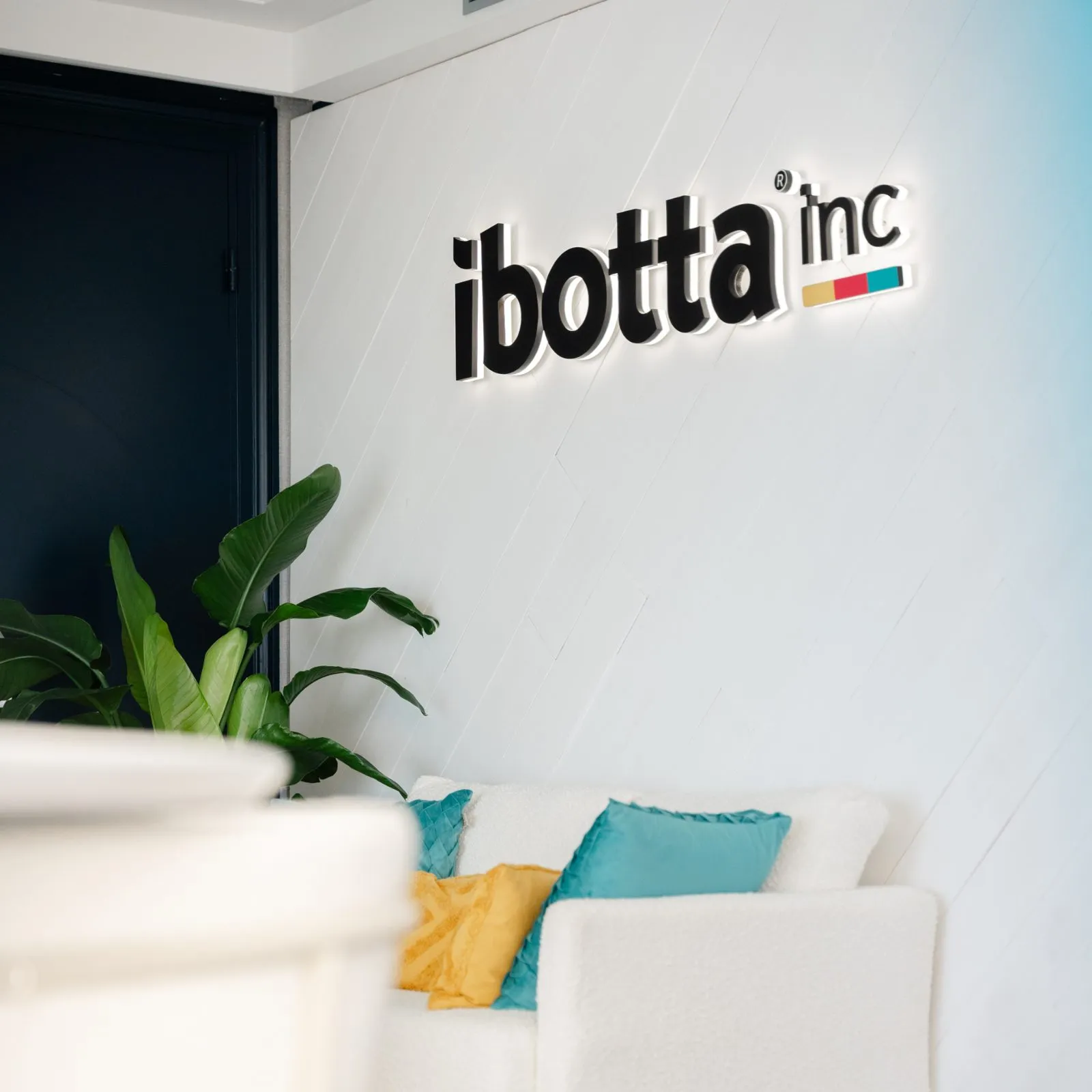 Branded wall and seating area in a brand activation space
