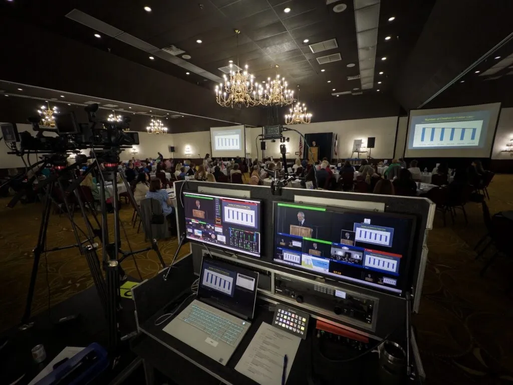 Video switching and monitoring station at the back of a ballroom event, run by Kerrville.LIVE