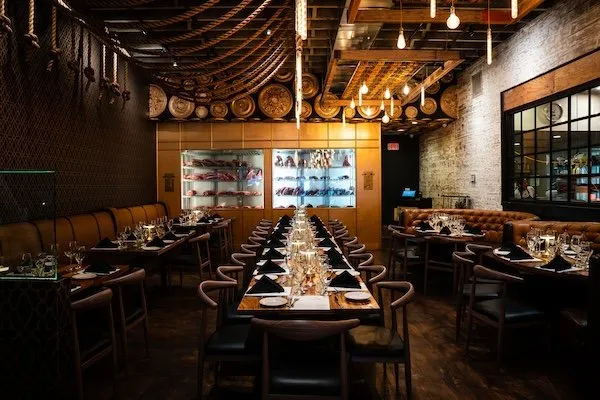 Long dinner table set in a restaurant dining room for the Marsh group dinner