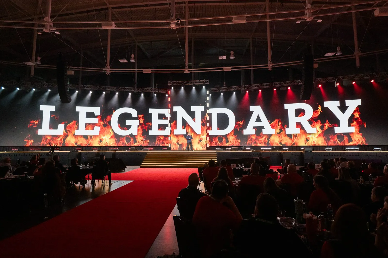 General session stage with a large 'LEGENDARY' sign and a red carpet aisle