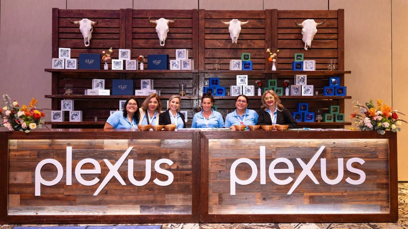 Team at a branded registration and welcome desk with floral accents