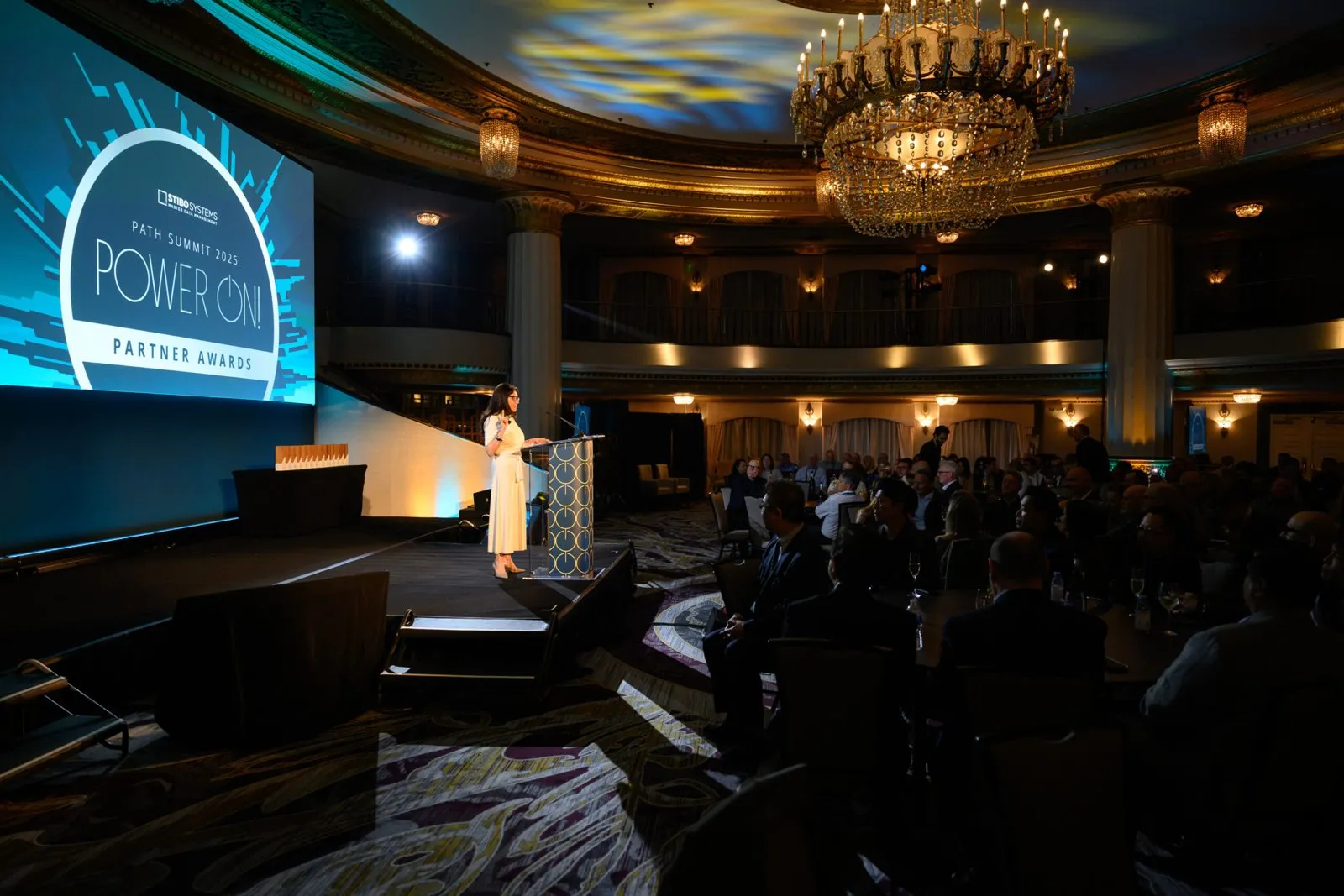 Awards presentation in a chandeliered ballroom