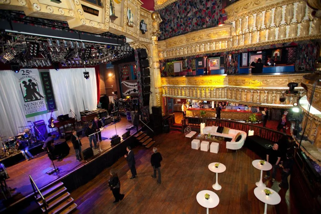 Lounge seating and high tables set up inside a large event venue