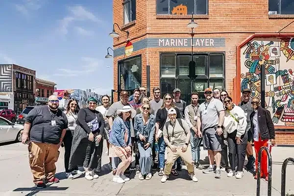 Group photo on a downtown street in front of a brick building