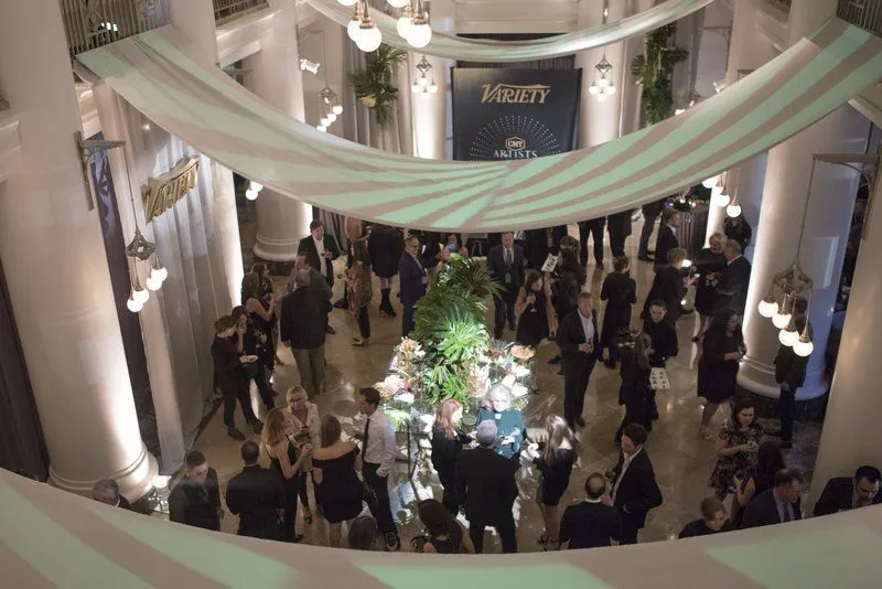 Guests in a decorated historic hall with draped ceiling fabric