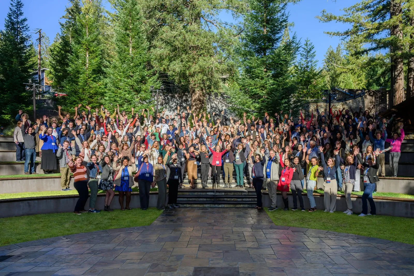 Large group of attendees gathered for a photo at an outdoor venue