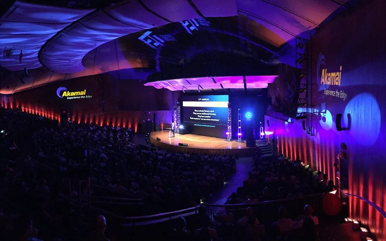 Company event stage with lighting and audience seating in a large hall