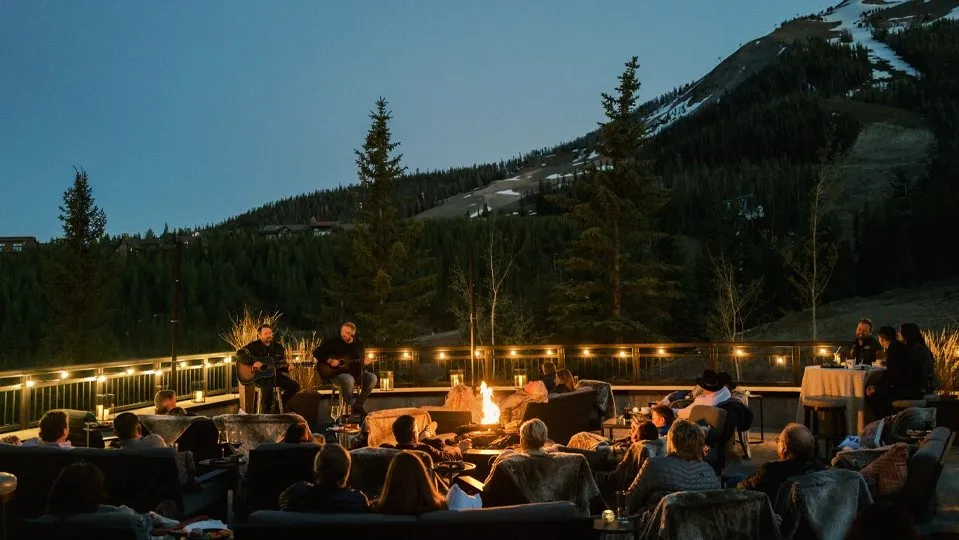 Fire pit seating at dusk with mountains behind during the Big Sky incentive trip