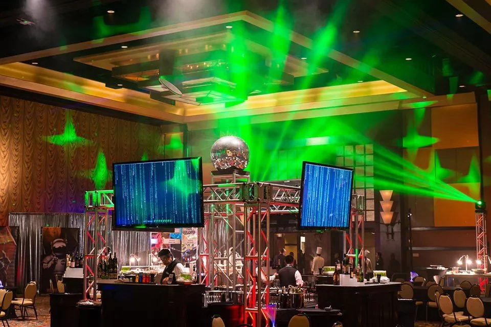 Themed dinner event with green lighting and large screens