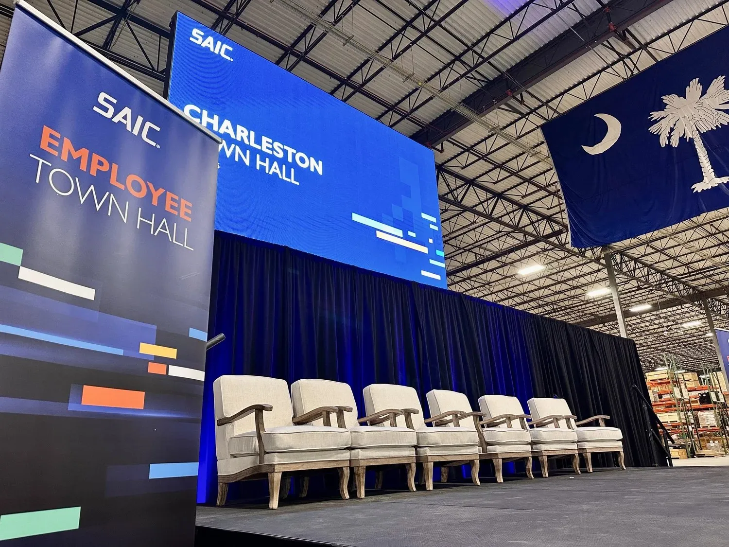 Conference stage with panel chairs and LED screens