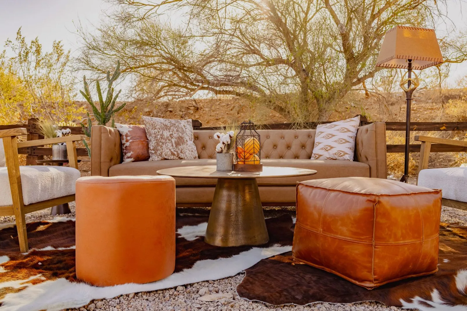 Lounge seating with ottomans and floor lamps in a desert setting