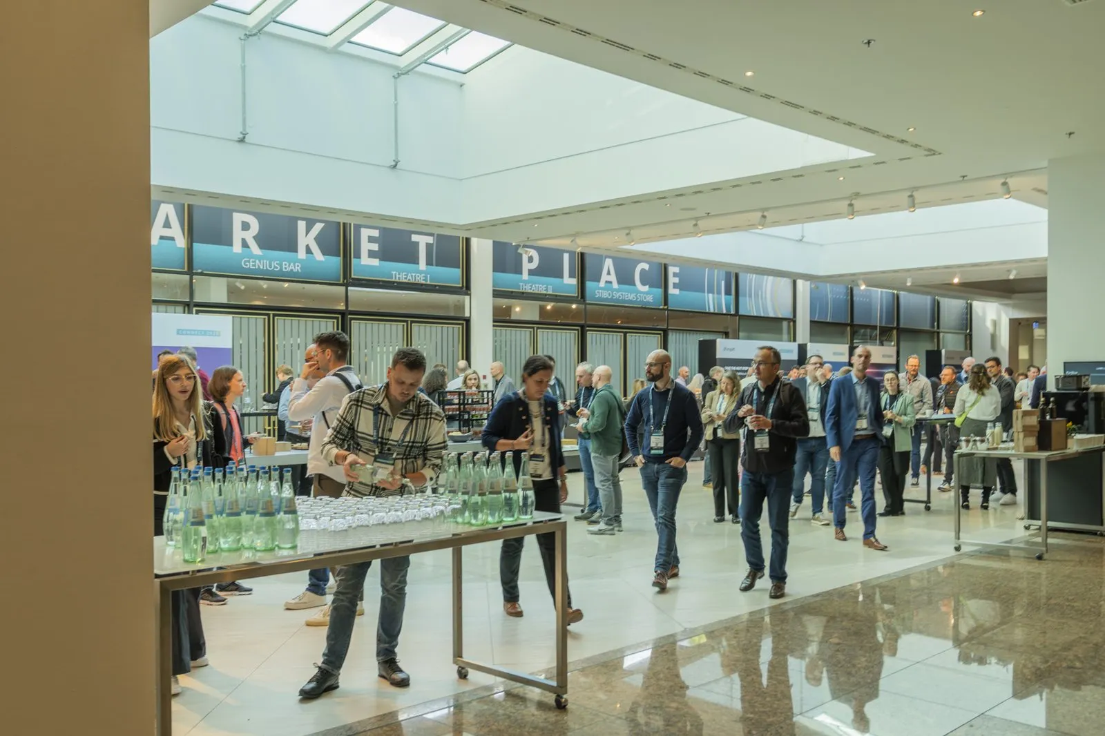 Attendees in a marketplace hall at a Stibo Systems event