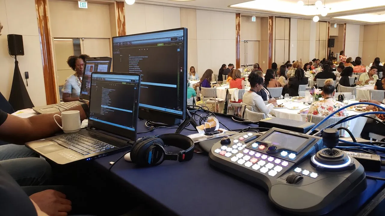 PTZ camera controller and monitors at the back of a banquet-room conference
