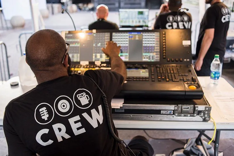 Production crew member at a lighting console during an event