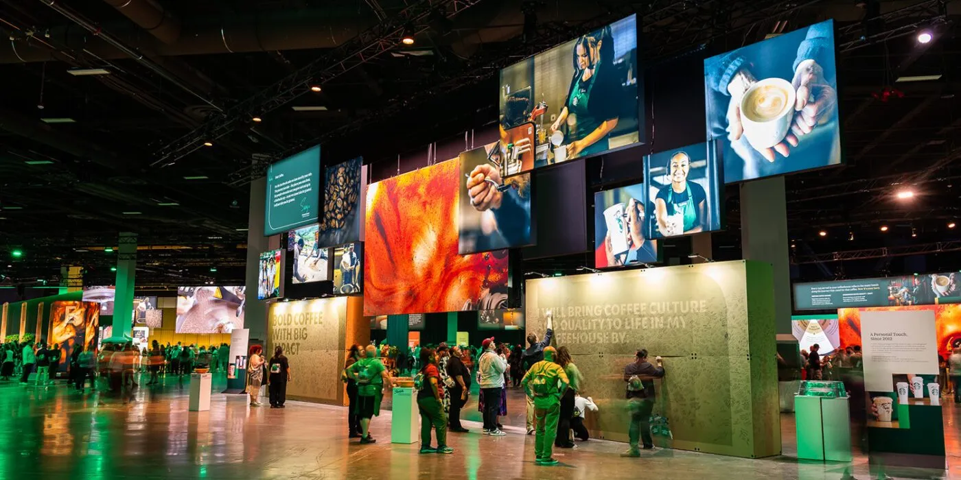 Branded exhibition hall with video displays at a leadership event