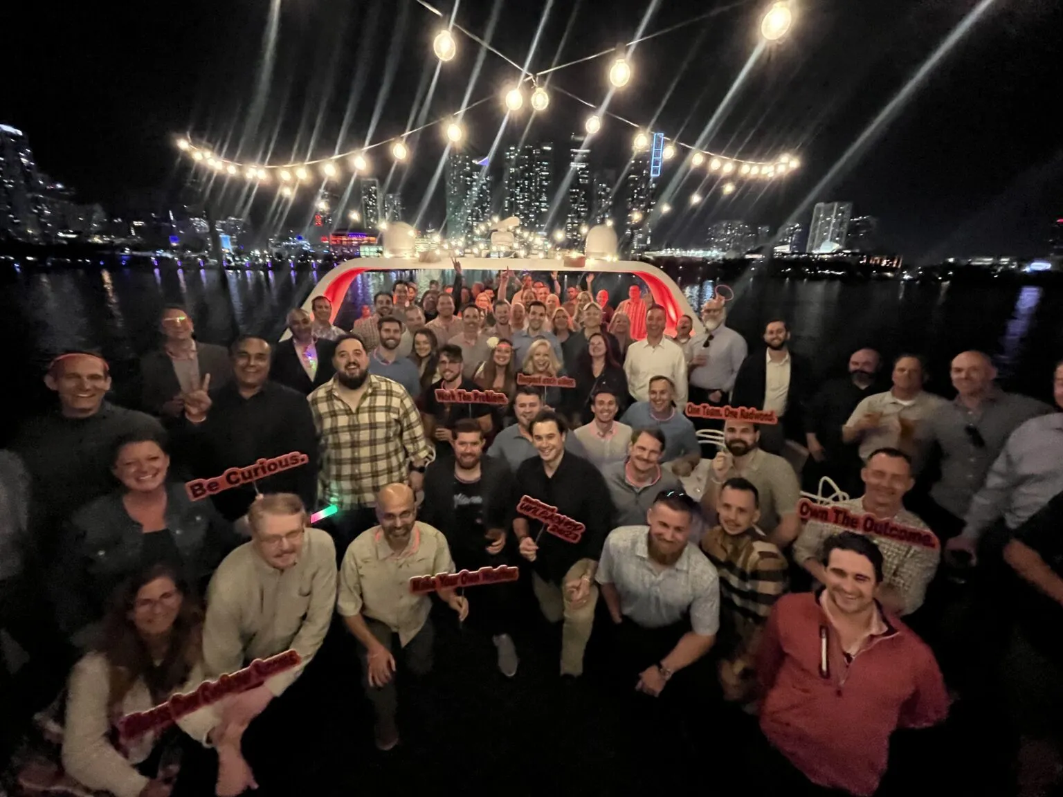Sales team gathered for a group photo at an evening kickoff event
