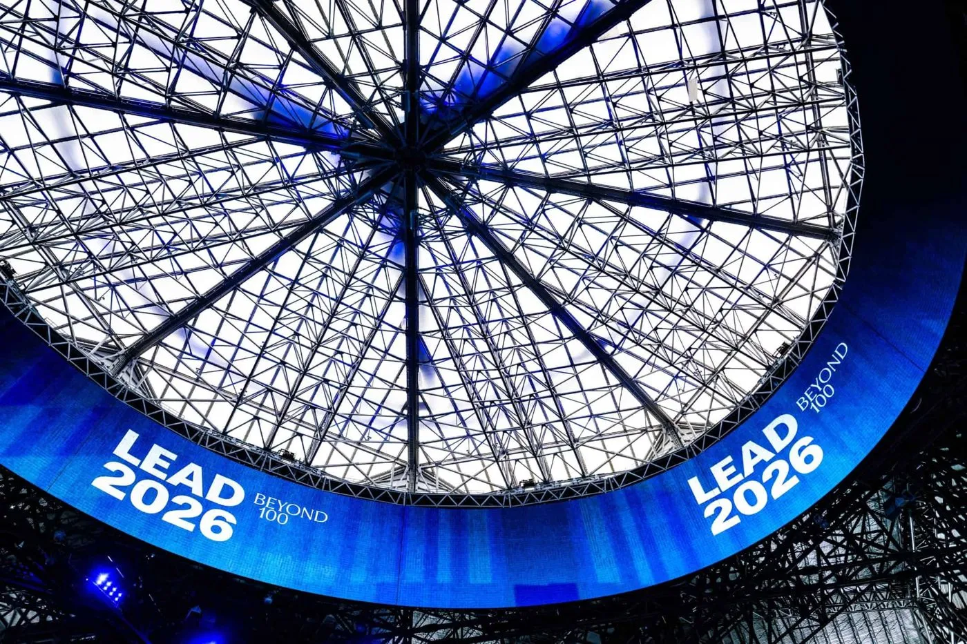 Conference stage with large curved screens under a glass dome