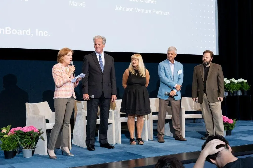 Speakers standing on a stage at a business event