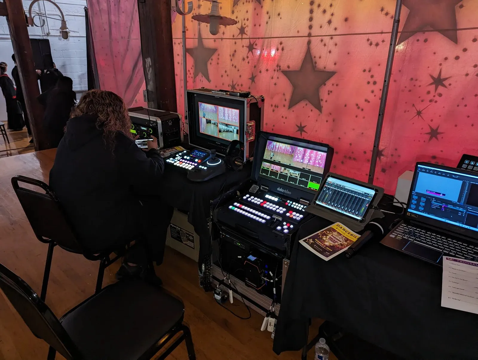 Operator at a flypack production station during an indoor event