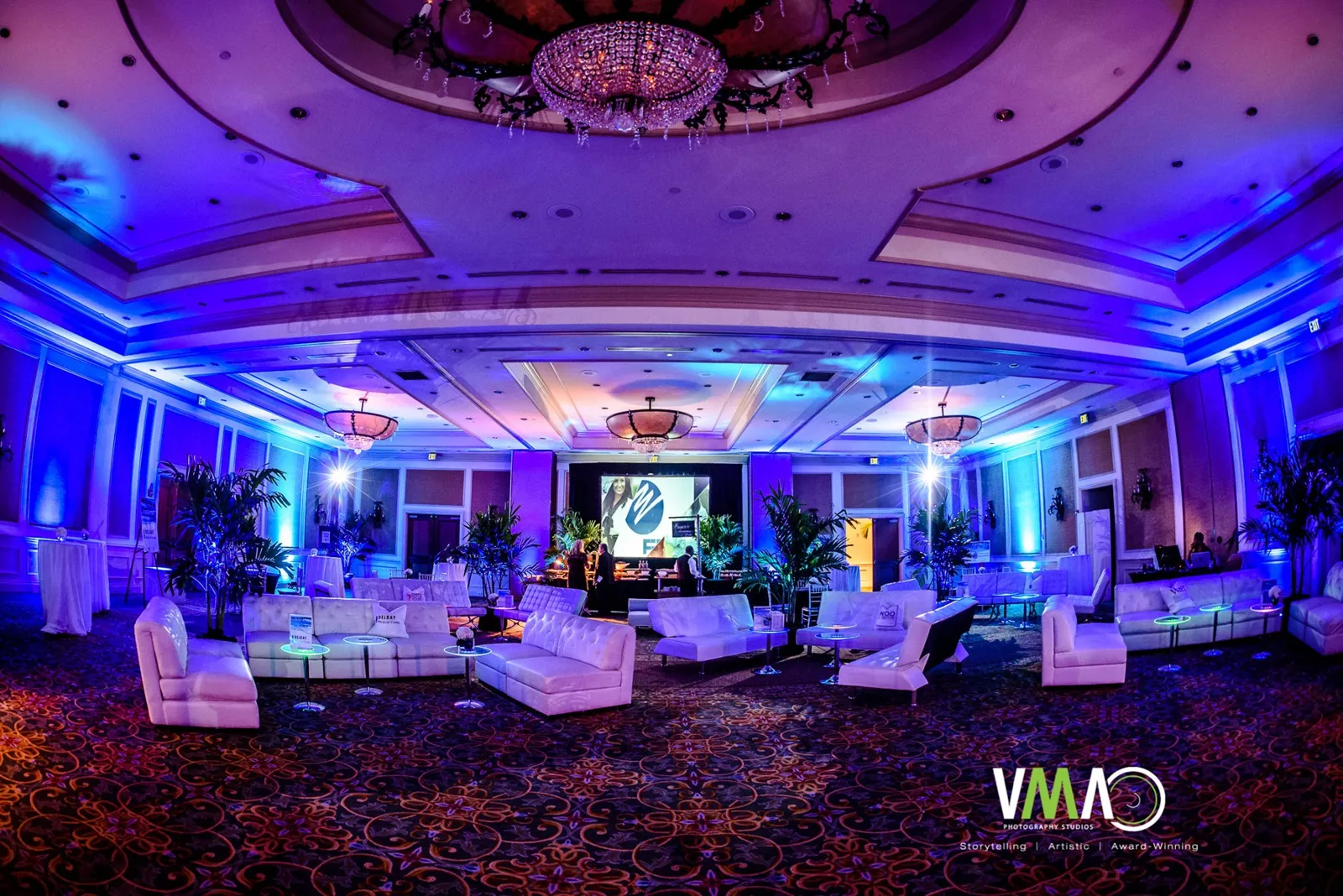 Ballroom lit in blue and purple for the Luminary Gala produced by Experience Epic Events