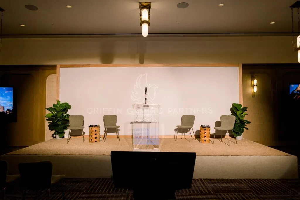 Stage with armchairs and a screen set for a presentation