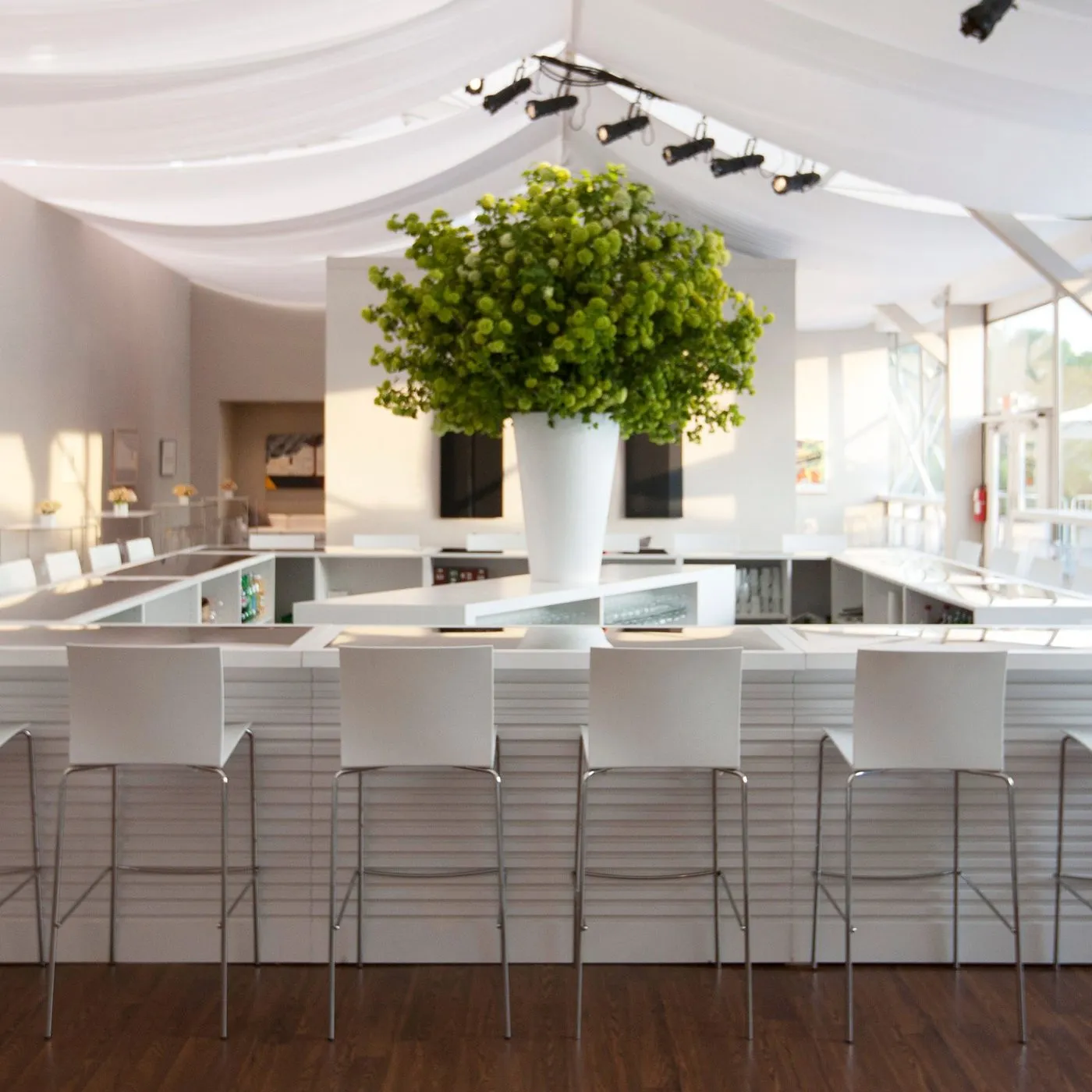 White lounge bar with seating for a corporate VIP event