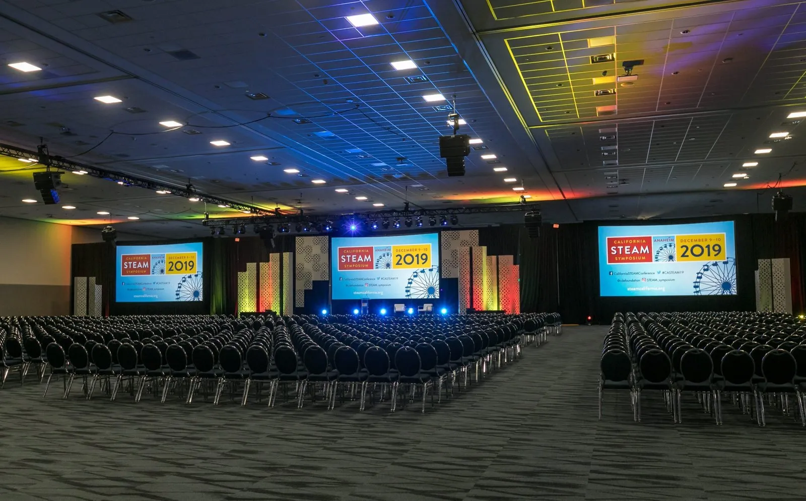 Empty general session hall with stage screens for the California STEAM Symposium