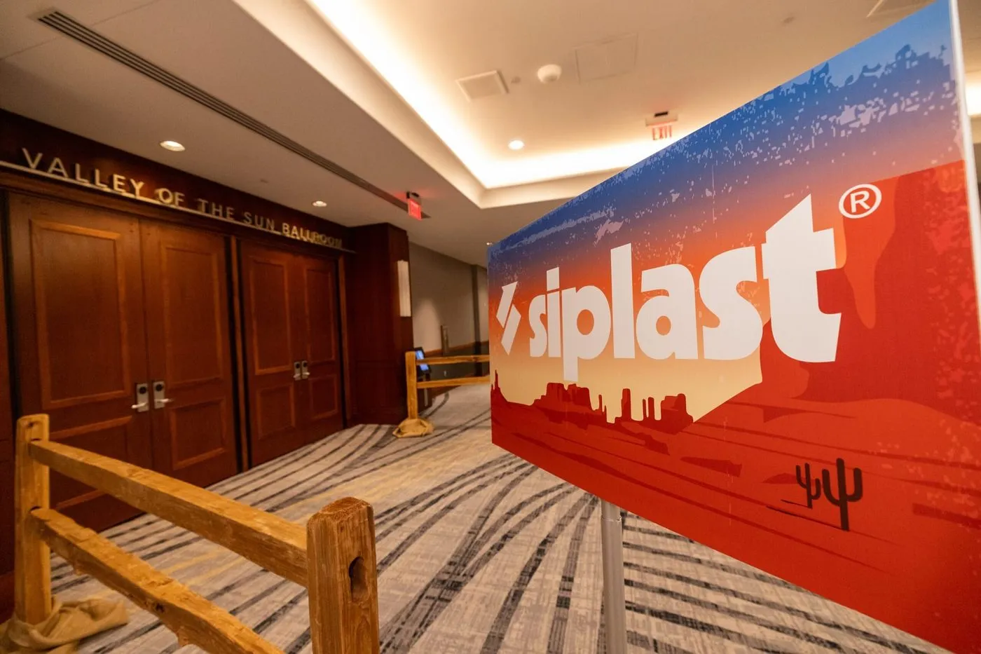 Branded corporate sign in a resort hallway at an incentive event