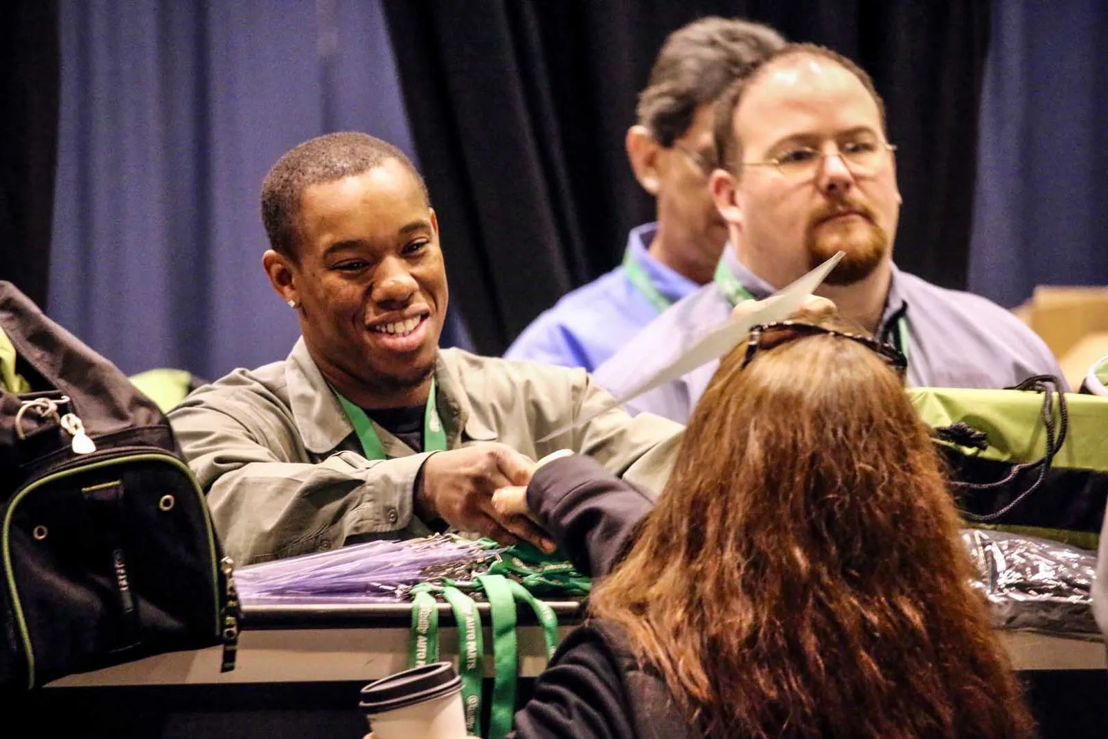 Attendees gathered at a conference check-in table